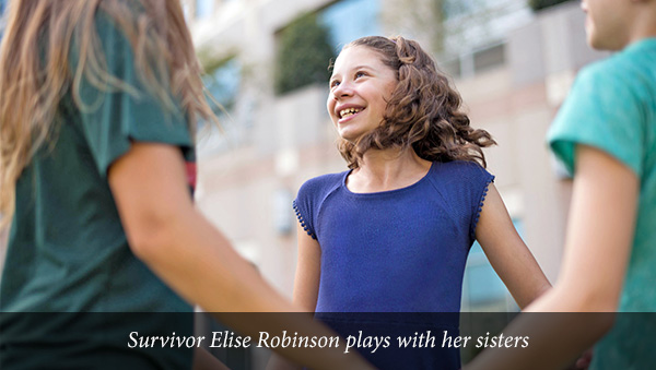 Survivor Elise Robinson plays with her sisters