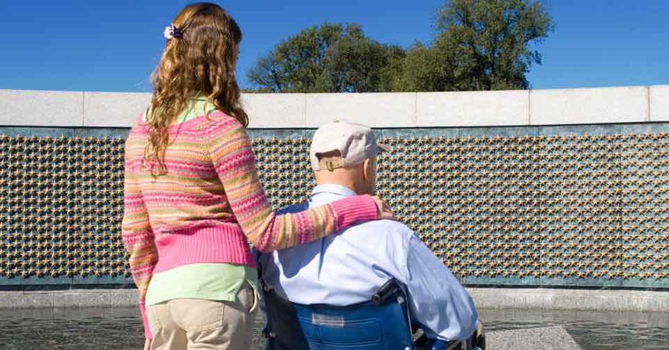 girl and granddad at war memorial