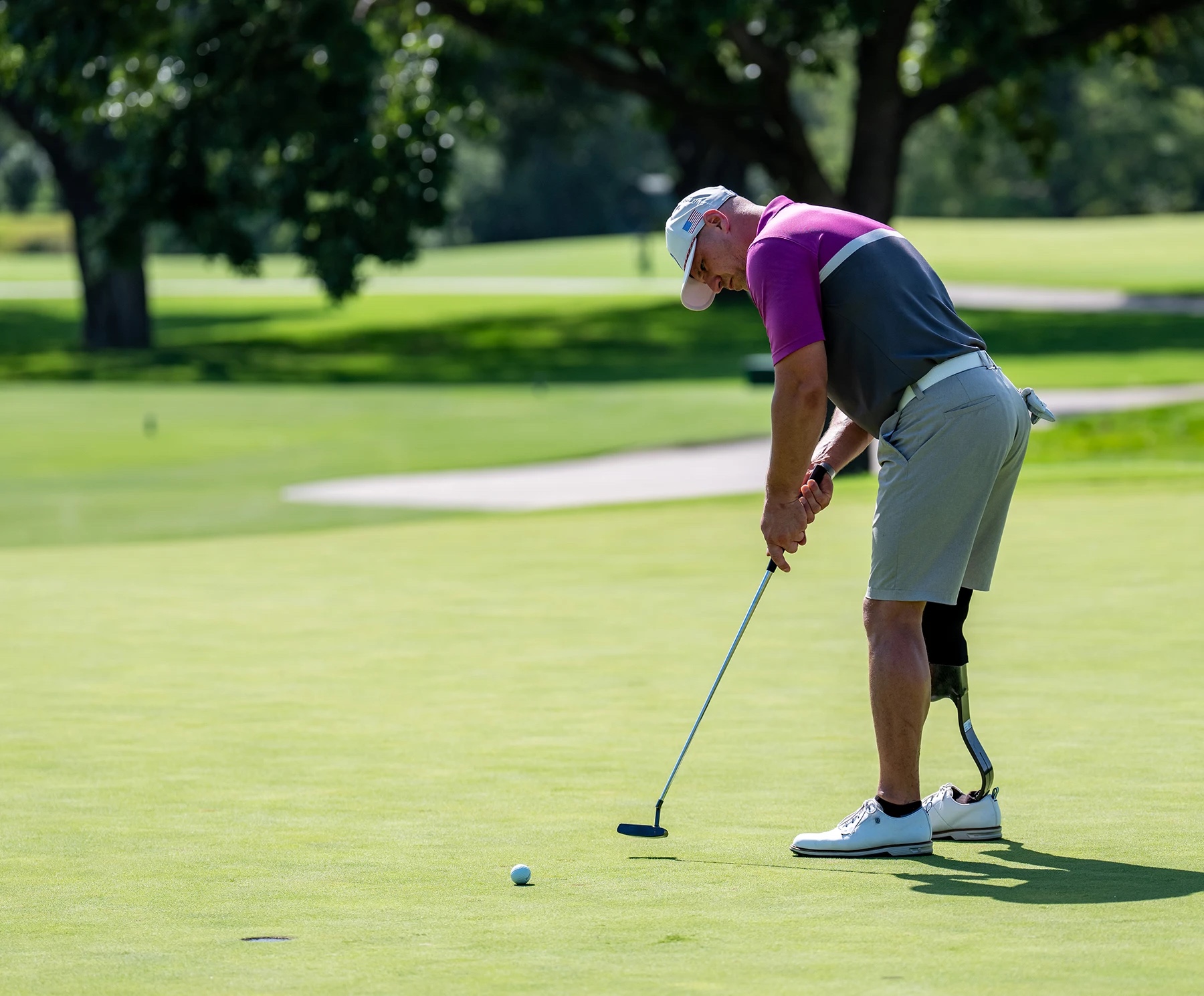 injured veteran lining up a putt on a green