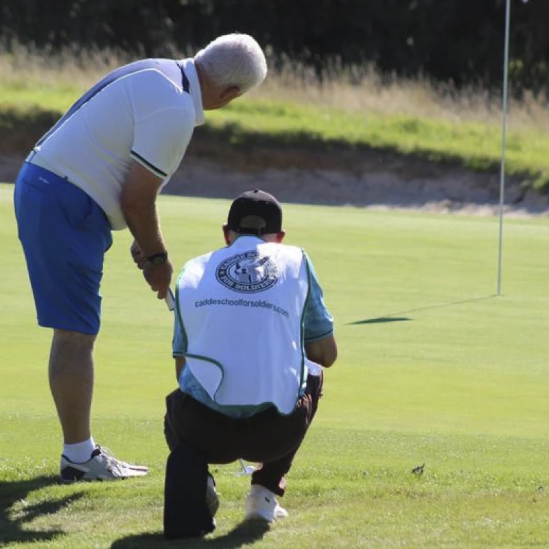injured veteran caddying at a golf tournament