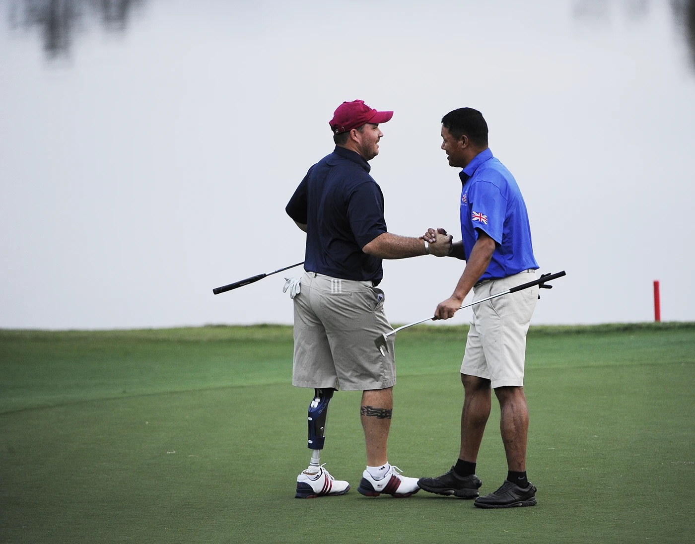 two happy veteran golfers walking and talking on a golf course