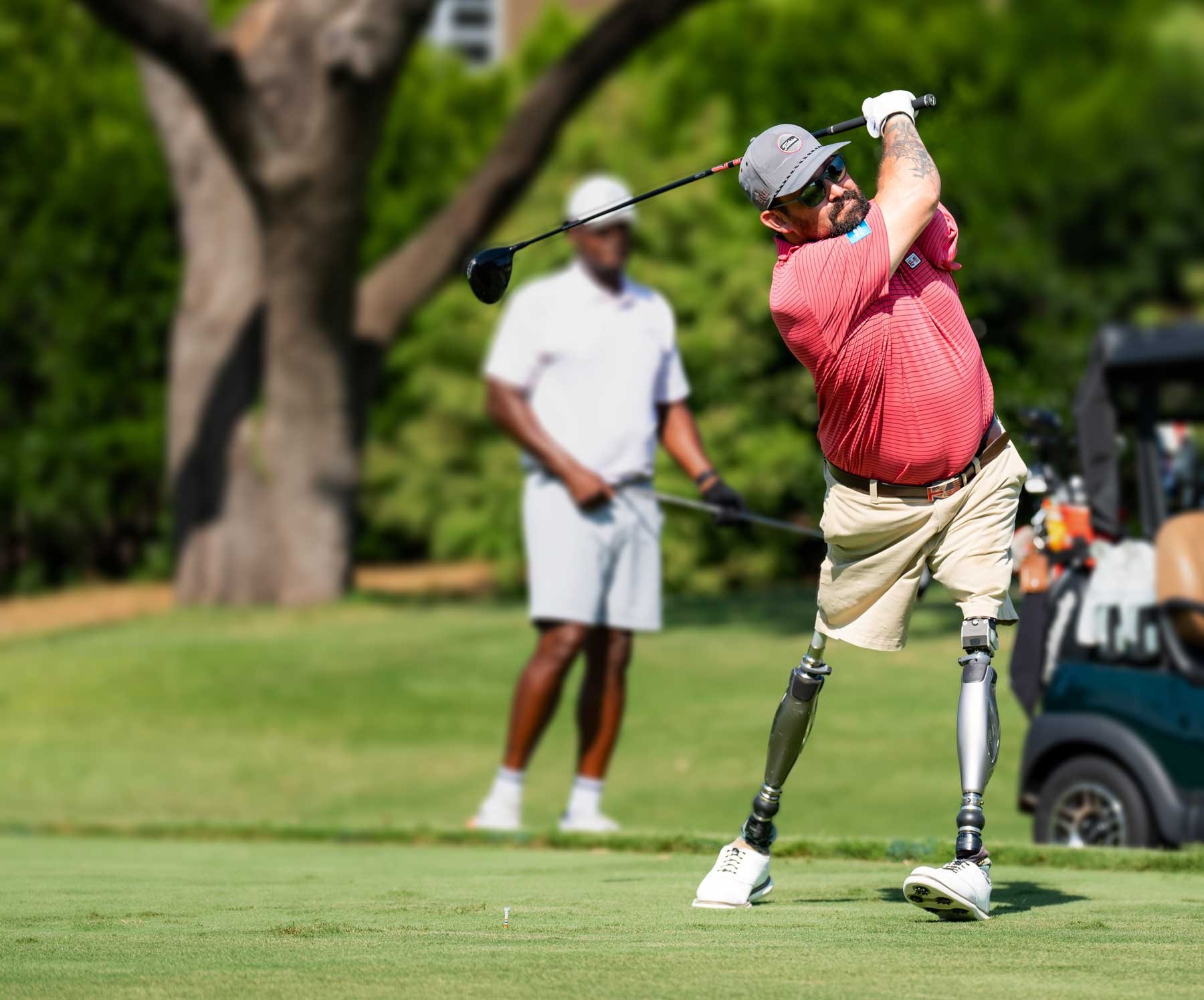 injured veteran golfer teeing off on the golf course