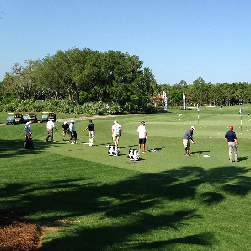 group of wounded veterans on a driving range practicing golf